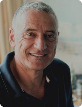 Smiling older man in dark blue polo shirt