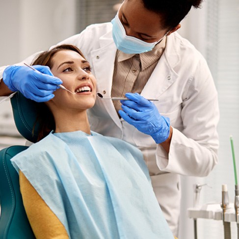 Woman in dentist’s chair undergoing treatment