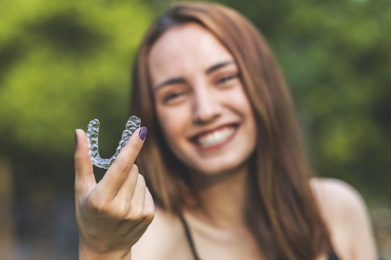 hand holding Invisalign aligner